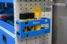 Portabombolette montato sulla parete dell’allestimento con bombolette spray